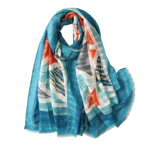 Ethnic style geometric scarf with colorful blue and orange print and fringe edges