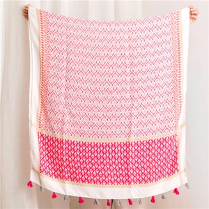 Detailed view of bohemian cotton linen scarf featuring pink floral patterns and fringe tassels