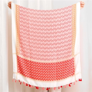 Detail of bohemian cotton linen scarf with ethnic geometric patterns and colorful tassels