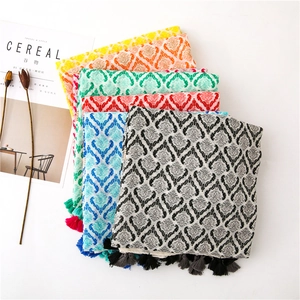 Flat lay of colorful bohemian cotton linen scarves with tassels and vintage patterns
