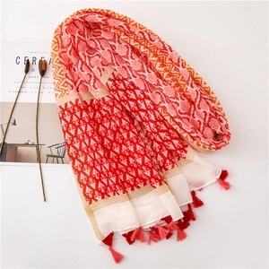 Detailed view of bohemian floral cotton linen shawl with colorful tassels and soft texture