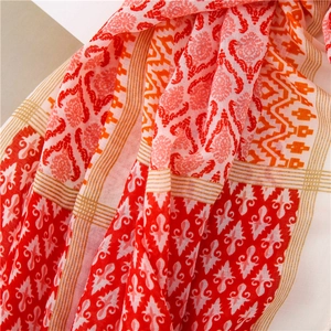 Detail of bohemian cotton linen scarf with ethnic floral patterns and soft tassel trim