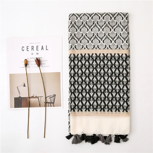 Close-up of retro floral print cotton linen scarf with tassels and bohemian stripes