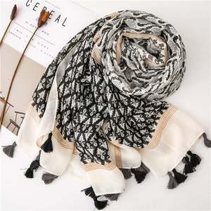 Detailed shot of ethnic print linen scarf with two-tone tassels and vintage pattern