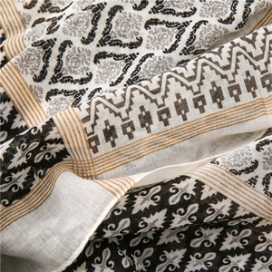 Macro detail of bohemian cotton linen scarf with vintage floral print and tassels