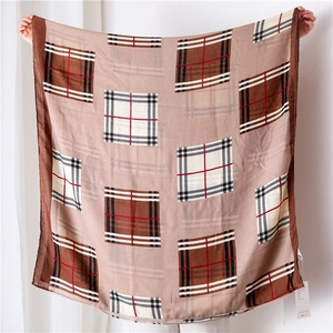 Detailed view of the earth-tone checkered cotton-linen scarf with fringed edges