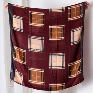 Detail of burgundy tartan check pattern shawl made of soft cotton linen fabric