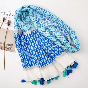 Detailed view of bohemian cotton linen scarf with blue ethnic prints and fringe tassels
