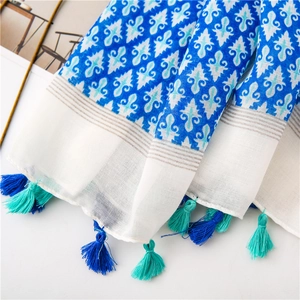 Detail of bohemian cotton linen shawl with geometric patterns and fringe tassels