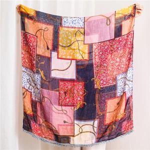 Detailed view of large vintage scarf featuring colorful patchwork prints and lace trim