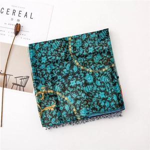 Detail of vintage floral print scarf with chain patterns and grey tassel trim