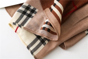Detailed close-up of soft plaid fabric texture with brown and red checkered pattern