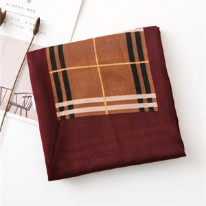 Detail of burgundy scarf showing high-quality plaid pattern texture and cotton-linen fabric