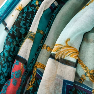 Detail of vintage floral and chain print scarf with lightweight texture and rich colors