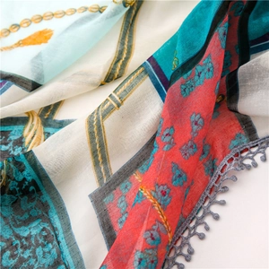 Detail of printed scarf with floral chain patterns and grey lace crochet trim