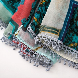 Detail of bohemian floral cotton linen scarf with gray crochet lace and pompom trim