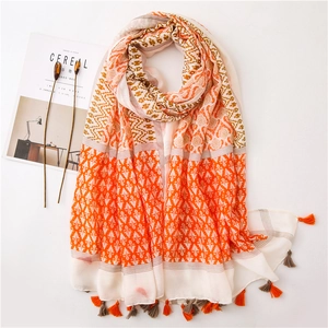 Detailed close-up of geometric ethnic cotton linen scarf with soft fringe and tassels