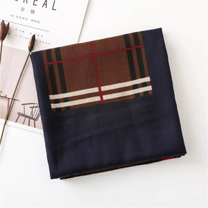 Close-up of thick plaid cotton-linen scarf with elegant navy and brown checkered pattern