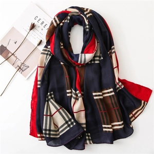 Classic checkered cotton linen scarf in navy and red, draped on a minimalist white surface