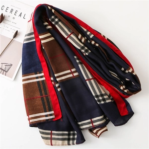 Flat lay detail of a multicolor plaid cotton linen scarf with soft texture and fringes