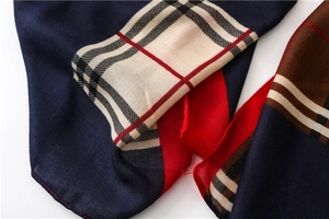Close-up of British style checked scarf featuring blue and brown panels with fine weave texture