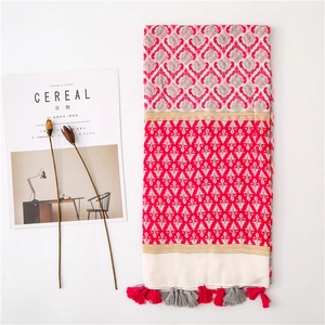 Detail of pink cotton linen shawl with damascus pattern and fringe tassels