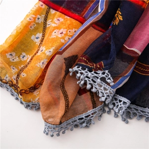 Detail shot of multi-color chain print cotton linen scarf with grey lace tassel edges