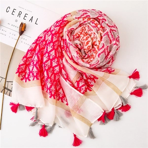 Detail of bohemian cotton linen scarf with ethnic patterns and colorful tassels