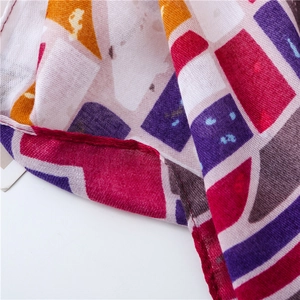 Detailed view of bohemian geometric print scarf showing linen-blend fabric and woven texture