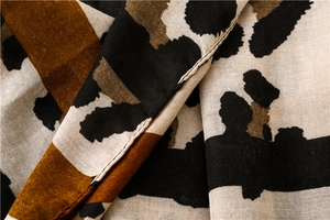 Close-up of leopard print cotton linen scarf with soft texture and detailed weave pattern