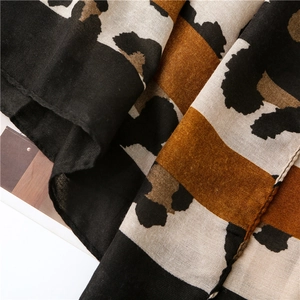 Close-up of leopard print linen scarf showing premium breathable fabric texture and drape