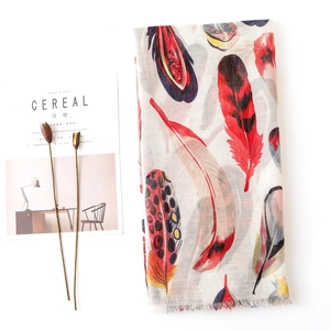 Linen cotton scarf featuring colorful feather prints and delicate fringe edges