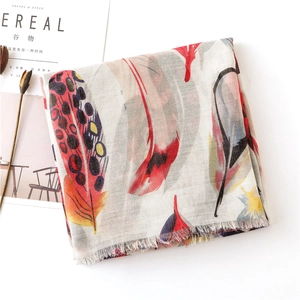 Detail of colorful feather print and fringe edge on lightweight cotton linen scarf