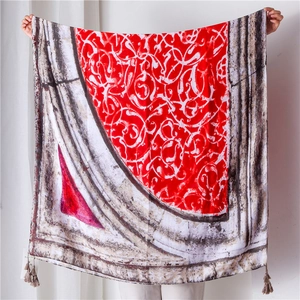 Detail of vintage geometric red floral scarf with elegant fringe trim and soft fabric texture