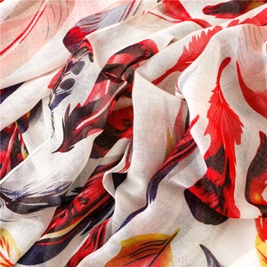 Detailed close-up of breathable cotton-linen fabric with colorful feather prints