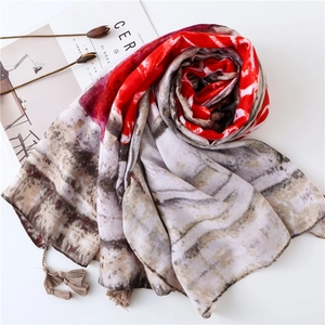 Vintage geometric print shawl with fringe tassels on white background with cereal magazine
