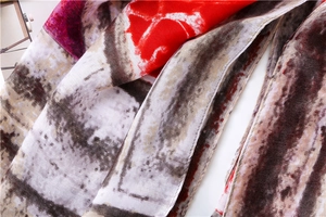 Detail of artistic geometric flame pattern and red color block on lightweight scarf
