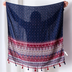 Detail of bohemian cotton linen scarf with ethnic floral print and tassel trim