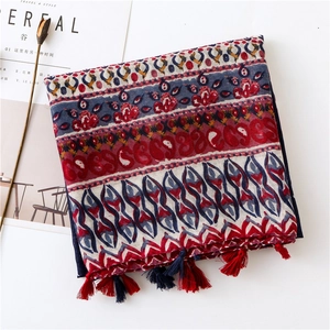 Detail of bohemian cotton linen scarf with ethnic floral prints and colorful tassels