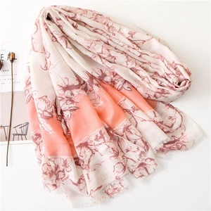 Floral print cotton linen scarf with soft pink and orange tones and frayed edges