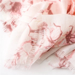 Artistic floral printed cotton linen scarf with soft pink abstract patterns and frayed edges