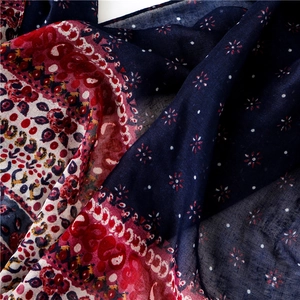 Detailed macro view of paisley prints and fine fabric texture on a bohemian shawl