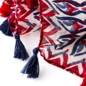 Detail of bohemian cotton linen scarf with vibrant geometric prints and tassel edges