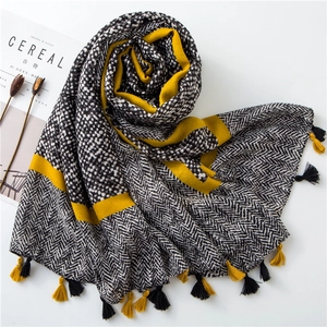 Flat lay of cotton linen scarf with polka dots, herringbone patterns and fringe tassels