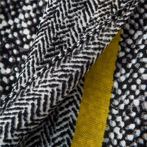 Detailed macro view of herringbone and leopard print patterns on a linen blend scarf