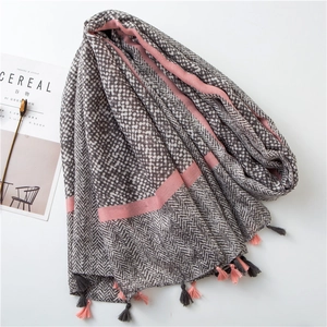 Detail of herringbone linen scarf with pink stripes, polka dots, and fringe tassels