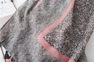 Detail of cotton linen scarf showing herringbone texture, pink stripes and tassel fringe