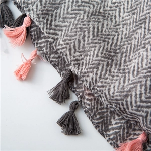 Macro view of chevron weave pattern and two-tone tassels on women's cotton linen scarf