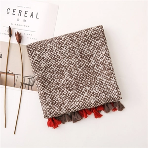 Detail of leopard print cotton linen scarf with red-brown tassels and knit texture
