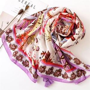 Châle de protection solaire à fleurs paisley avec pompons mauves sur fond épuré